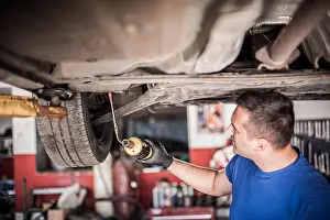 Maintain Prints: Car master mechanic repairer heating the screws with butane gas blow mini welding torch flamethrower burner in vehicle