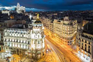 Car and traffic lights on Gran via street, main shopping street in Madrid at night. Spain, Europe. Lanmark in Madrid, Spain