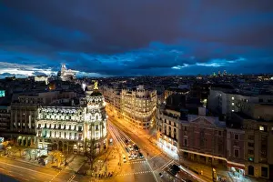 Car and traffic lights on Gran via street, main shopping street in Madrid at night. Spain, Europe. Lanmark in Madrid, Spain