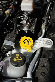 Generic Prints: Car windshield washer liquid reservoir yellow plastic cap. Close up shot, no people