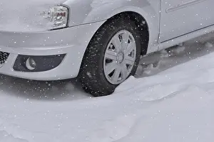 Car with winter tires on the snow covered road