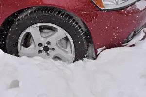 Car with winter tires on the snow covered road