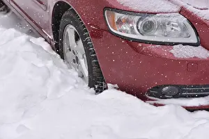 Car with winter tires on the snow covered road