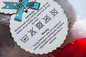 Tags Prints: Care & use Care washing symbols and instructions on label tag on soft toy together with warning message