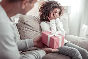 Spare Time Prints: Careful good father presenting a nice gift to a girl