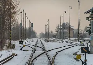 Cargo train with motor engine in winter snowy morning in cold village Lenesice CZ 12 09 2023