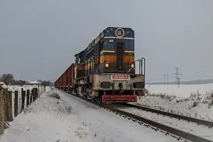 Turntable Prints: Cargo train with motor engine in winter snowy morning near cold village Lenesice CZ 12 09 2023