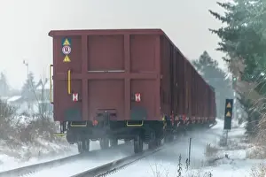 Cargo train with motor engine in winter snowy morning near cold village Lenesice CZ 12 09 2023