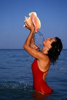 Beaches Prints: Caribbean woman holding conch shell and pouring water on self