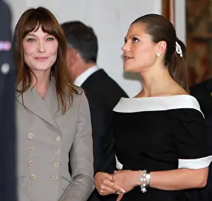 Royals Prints: Carla Bruni (L) bids farewell to Crown Princess Victoria of Sweden (R) after a reception at Elysee Palace in Paris