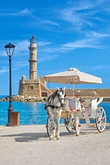 Images Dated 25th June 2017: Carriage with horse on the Venetian Harbour, lighthouse in the background, Chania, Crete Island