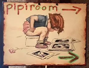 Lavatory Prints: Cartoon drawing of little boy sitting on a potty reading magazines as signboard to Toilet WC pipi room France