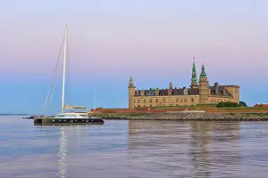 Watercraft Prints: A catamaran for anchor at Kronborg Castle (a UNESCO World Heritage Site since 2000) at dusk in Helsingor