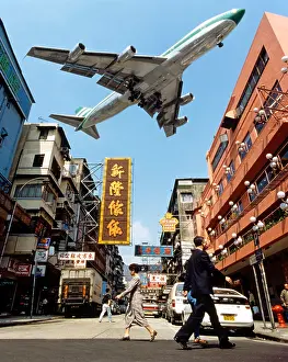 cathay pacific aircraft approaching kai tak airport rooftops kowloon