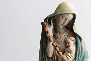 Catholic Mary statue, mother Mary holding the child Jesus with rosary