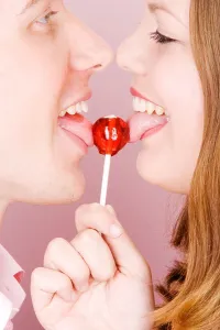 Licking Prints: Caucasian couple licking lollipop