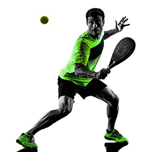 Back Lit Prints: one caucasian man playing Paddle tennis player isolated on white background