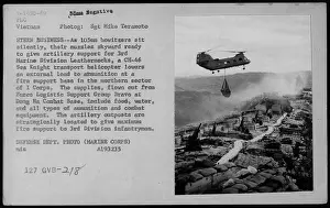 American Military Prints: A CH-46 Sea Knight transport helicopter lowers external supplies