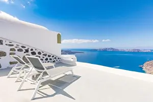 Chaise lounge in Santorini, Greece. Europe travel destination, luxury resort terrace, caldera sea view. Relaxing, peaceful vibes, summer mood. Romance