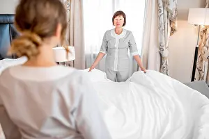 Bedclothes Prints: Chambermaids making a bed at the hotel