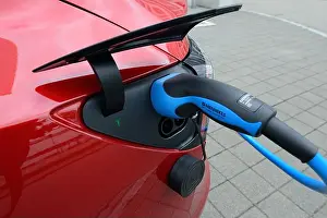 Concern Prints: Charging port with charging cable on car Tesla Model 3, Germany