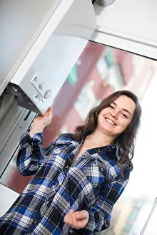 Control Panel Prints: Charming russian adult girl in shirt near boiler control panel