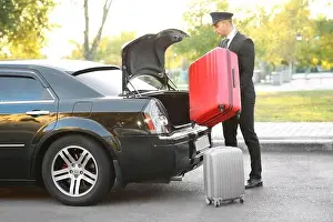 White Work Prints: Chauffeur putting suitcase in car trunk