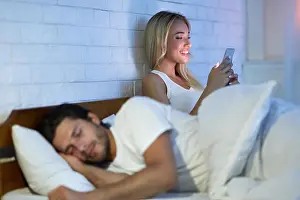 Texting Prints: Cheating Wife Chatting On Cellphone While Husband Sleeping In Bedroom