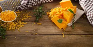 Cheddar Prints: Cheddar Cheese on a rustic wooden background. Top view