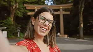 Meiji Prints: Cheerful, beautiful hispanic woman wearing glasses having fun making a confident selfie picture
