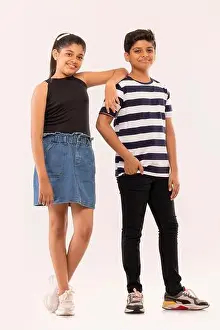 Two Persons Prints: Cheerful boy and girl standing together against white background