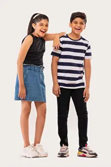 Two Persons Prints: Cheerful boy and girl standing together against white background