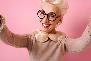 Kind Prints: Cheerful grandma taking selfie on the phone