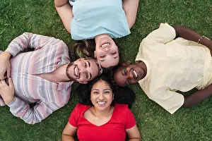 Bolivia Prints: A cheerful, multiethnic group of friends relaxing on the grass in a sunny park