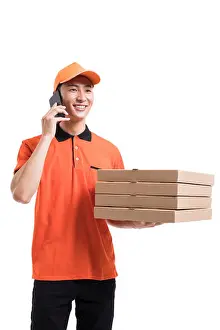 Three Quarter Length Prints: Cheerful pizza delivery person talking on cell phone