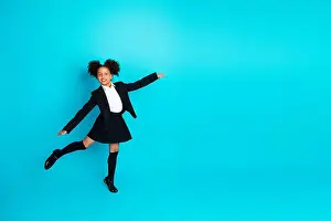 Preteen Prints: Cheerful schoolgirl in formal uniform posing against vibrant turquoise background with playful expression