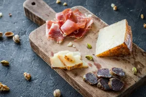 Delicatessen Prints: Cheese and meat platter. Spanish ham jamon serrano or Italian prosciutto crudo