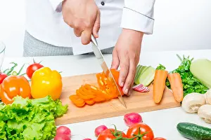Chop Prints: Chef cuts carefully sweet orange peppers for a vegetable salad