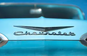 Light Blue Prints: Chevrolet chrome logo on the light blue hood of a classic car, Arizona, US