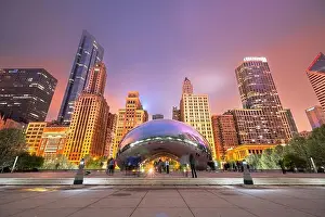 CHICAGO - ILLINOIS: MAY 12, 2018: Tourists visit Cloud Gate in Millennium Park in the evening