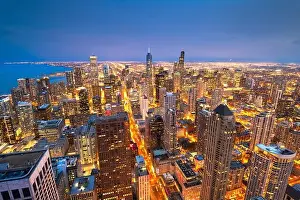 Chicago, Illinois, USA aerial cityscape with financial district buildings and Lake Michigan at dusk