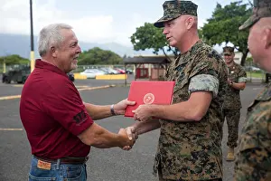 Hours Prints: Chief Warrant Officer 4 Brian Hough of the III Marine Expeditionary Force motor transport unit presented a certificate