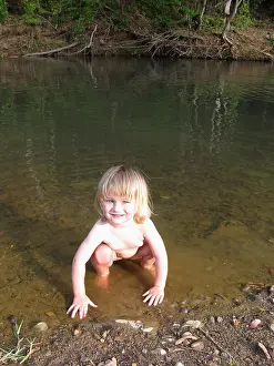 Squat Prints: Child girl naked squatting in river