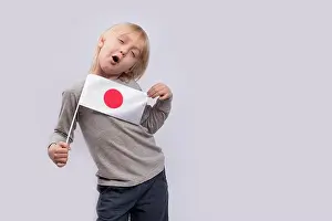 Citizenship Prints: Child holds flag of Japan and makes faces. Gay boy with Japanese flag