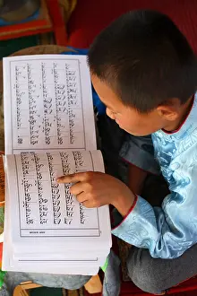Mongolia Prints: Child monk reading a pray book, Mongolia