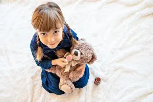 Injection Prints: child treats a bear. The game of the doctor. Selective focus