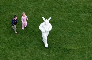 Youngsters Prints: Two children chasing a giant Easter bunny