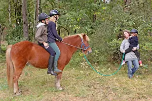 Europeans Prints: children horseback riding in a forest