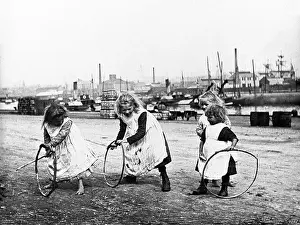 Children Playing Prints: Children playing with stick and hoops