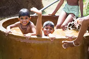 Preteen Prints: Children playing in a trough of water in Rajasthan, India